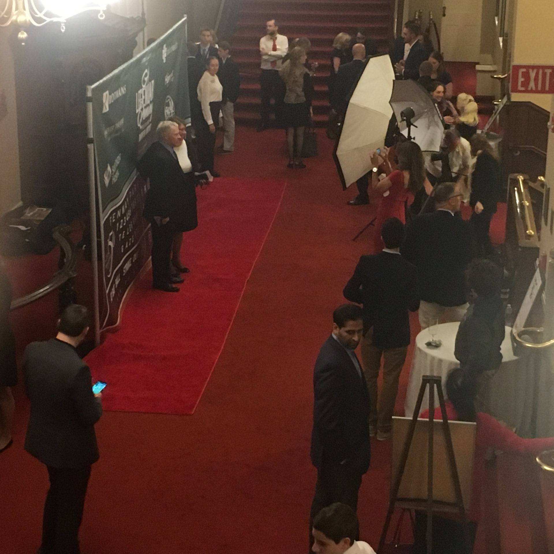 Guests arriving on a branded red carpet