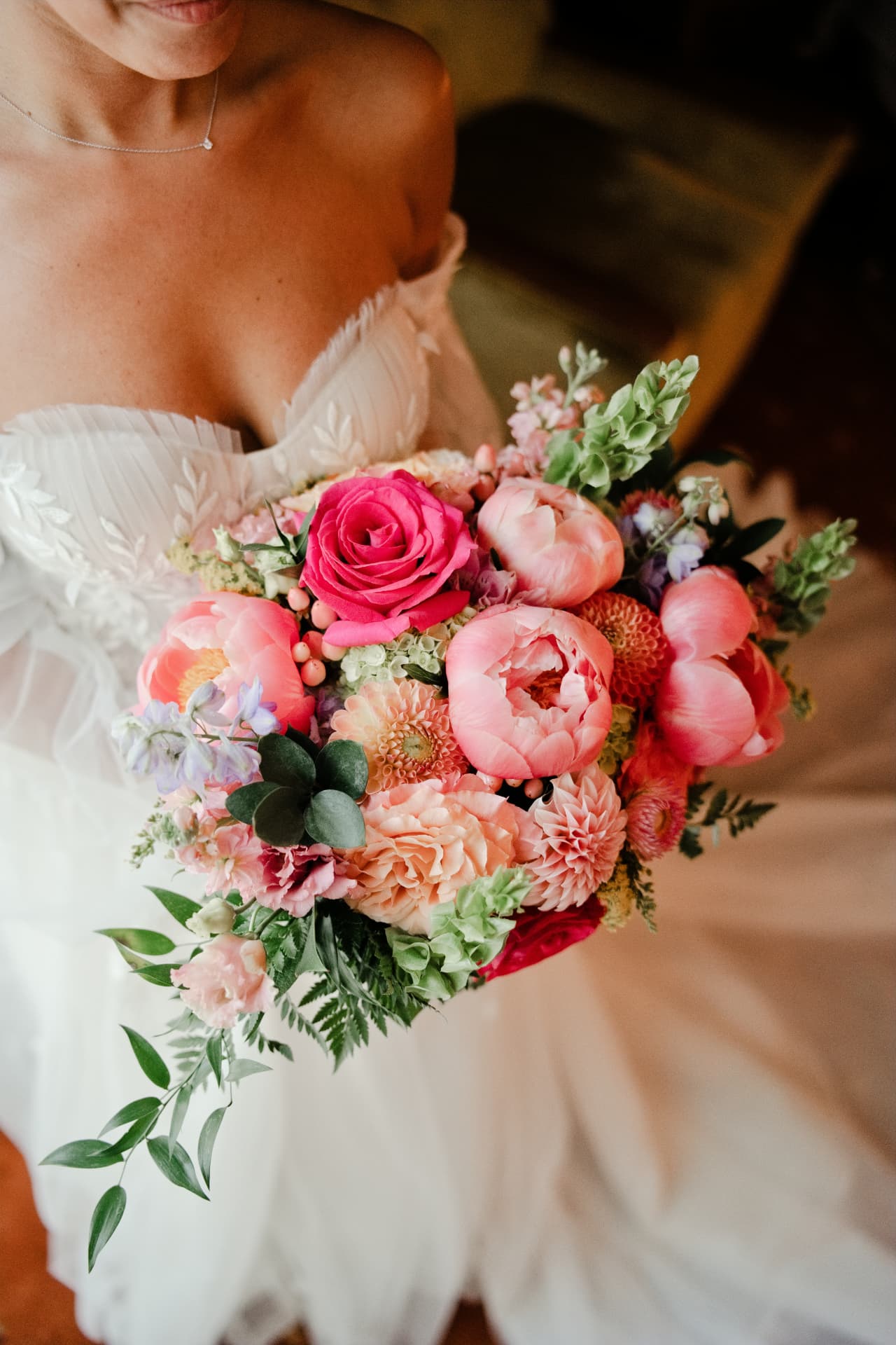 A bride holding a colorful bouquet