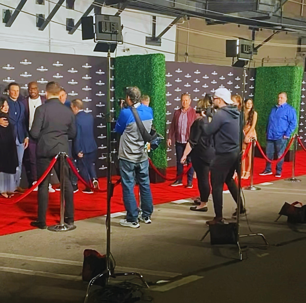 A red carpet setup with photographers and lighting
