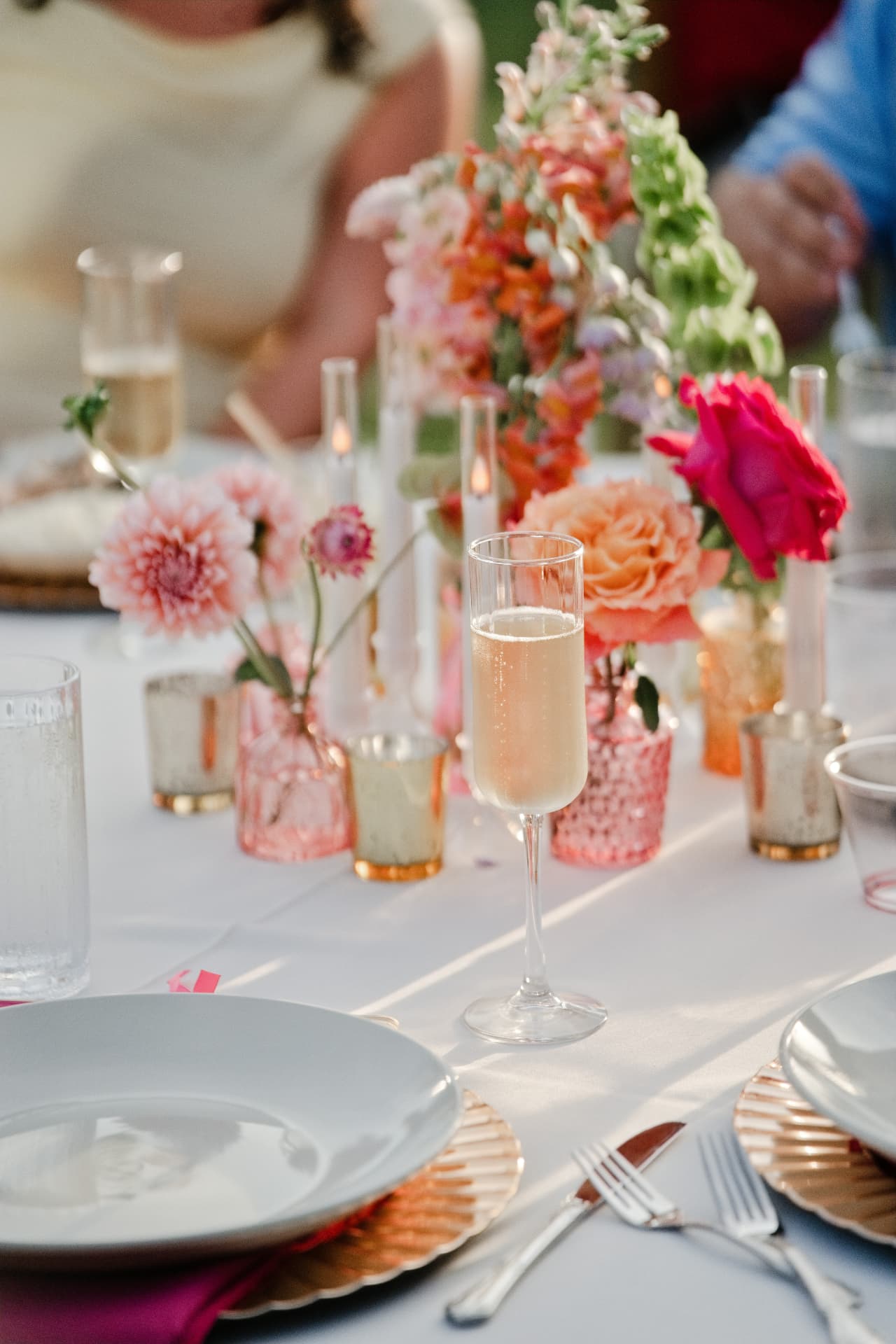 A place setting with sparkling wine and flowers