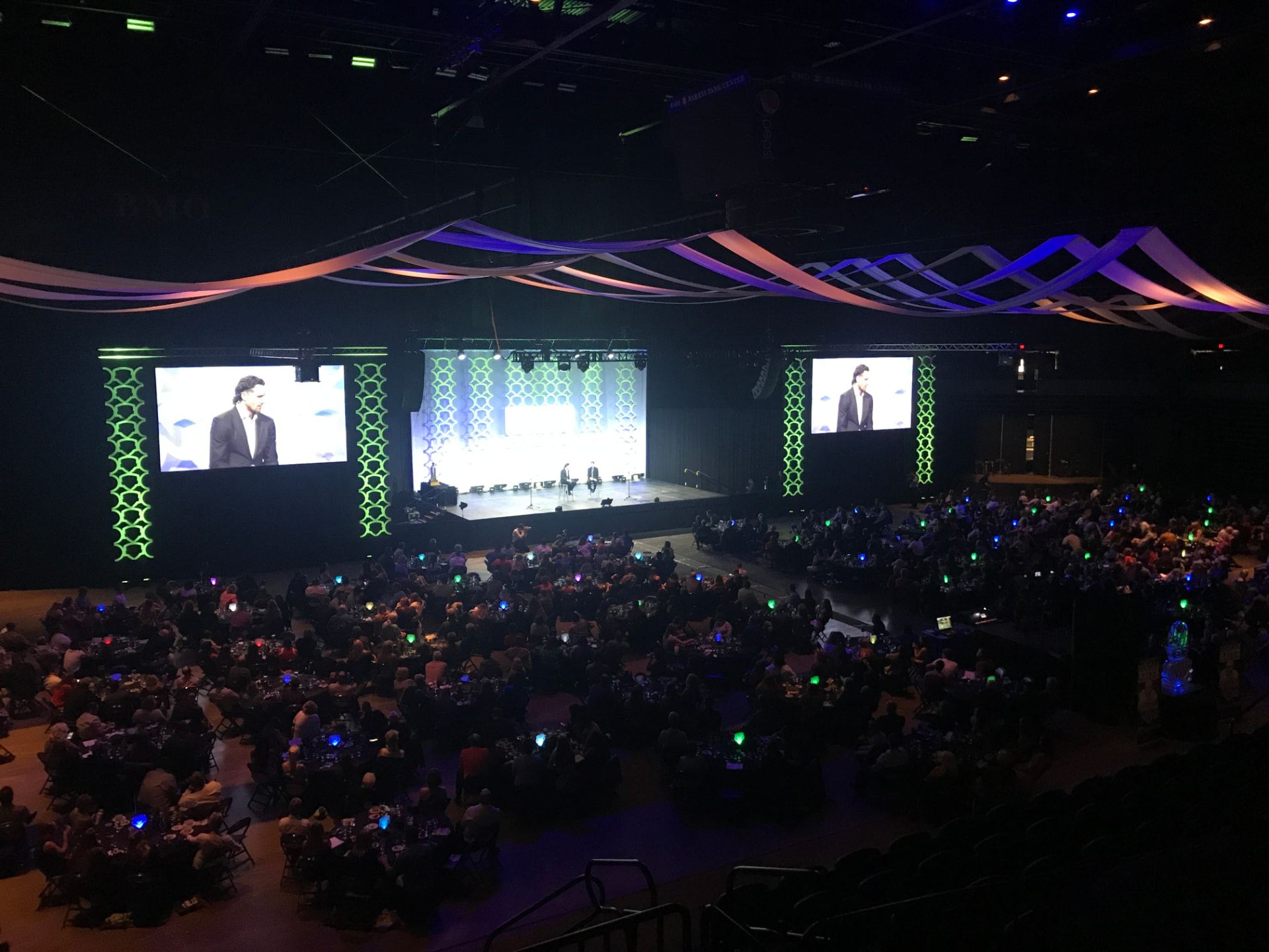 A large banquet hall with projection screens