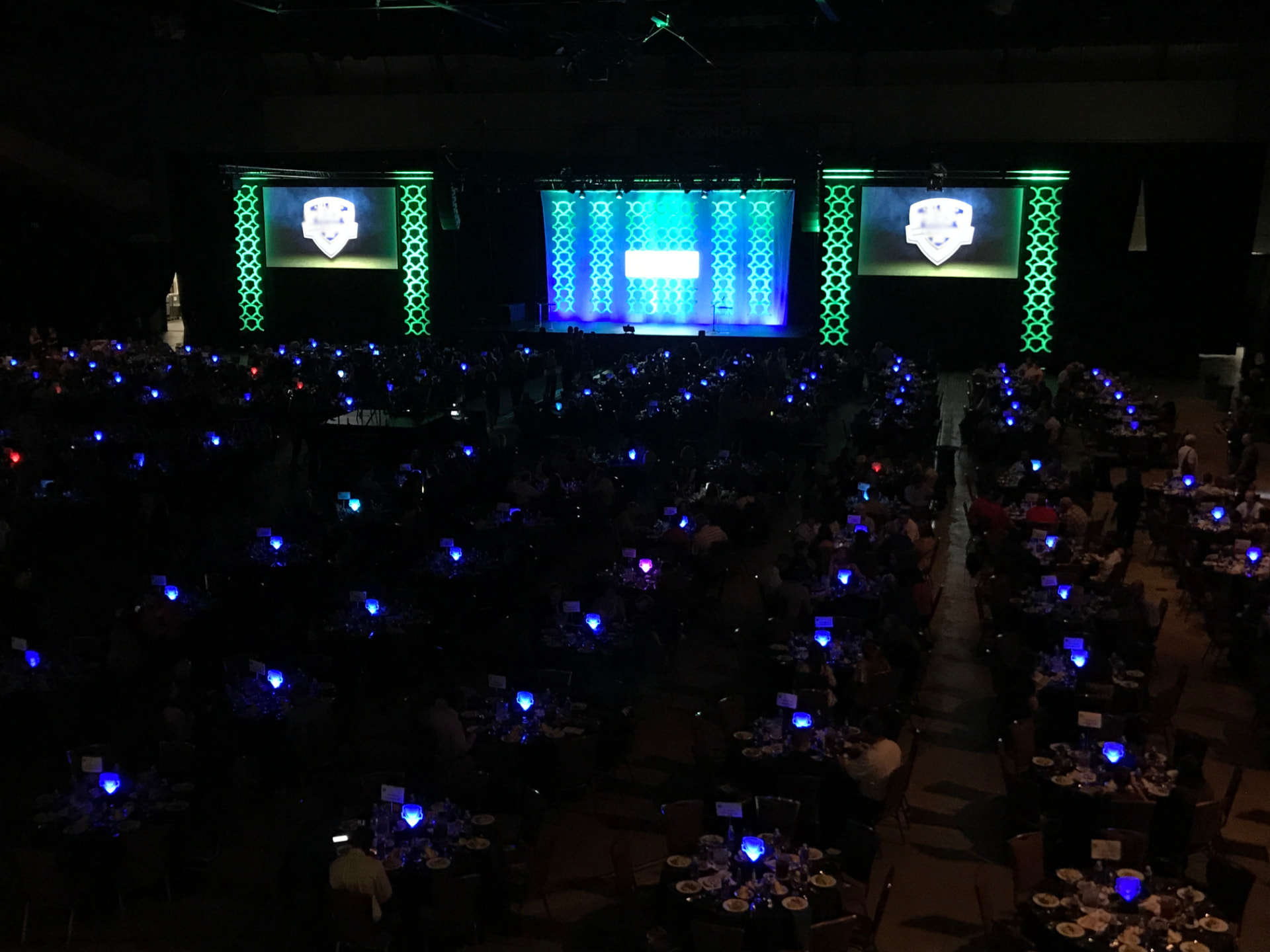 A large banquet with a brightly lit stage